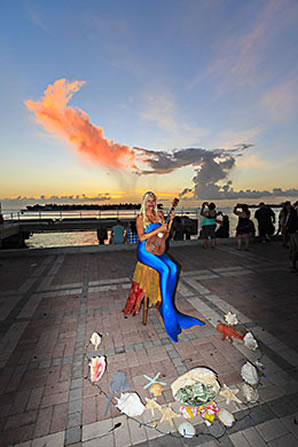 Mermaid playing guitar on the dock, Mallory Square