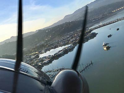 Seaplane landing near houseboats